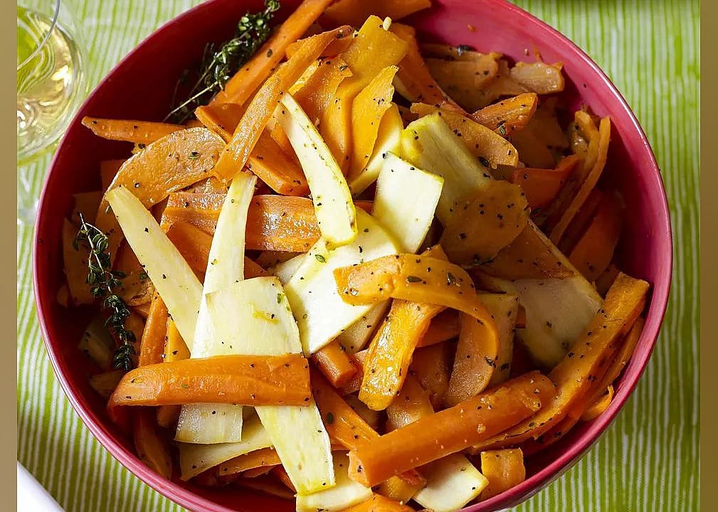 Roasted sweet potatoes and vegetables with thyme and maple syrup