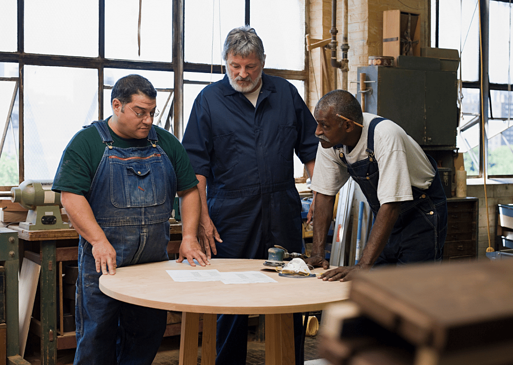 Carpenter helpers discuss a project
