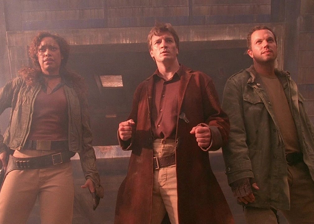 Actors Gina Torres, Nathan Fillion, and Adam Baldwin ready to fight.