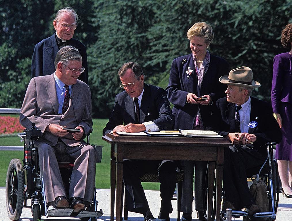 President George Bush signing the Americans with Disabilities Act of 1990