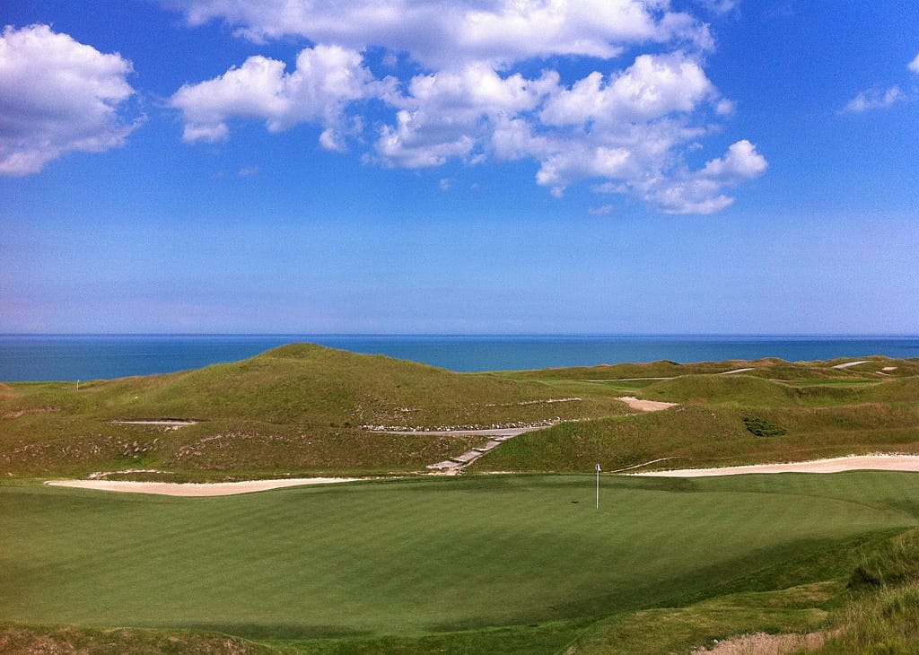 A golf course on the water.