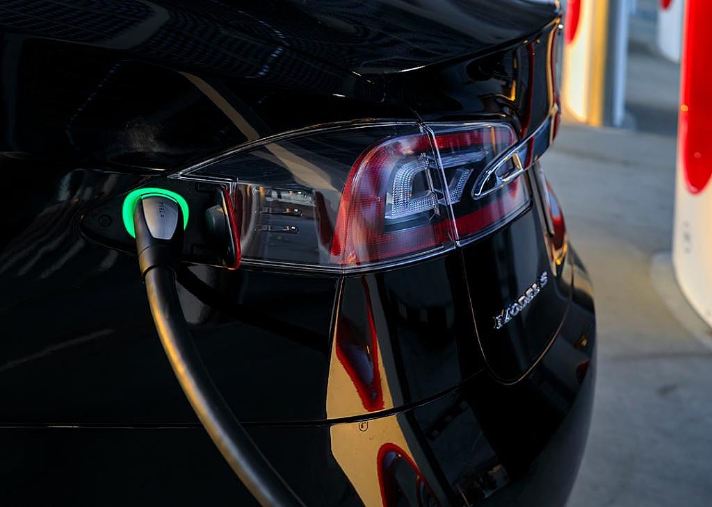 Charging port of a black Tesla Model S 75D car.