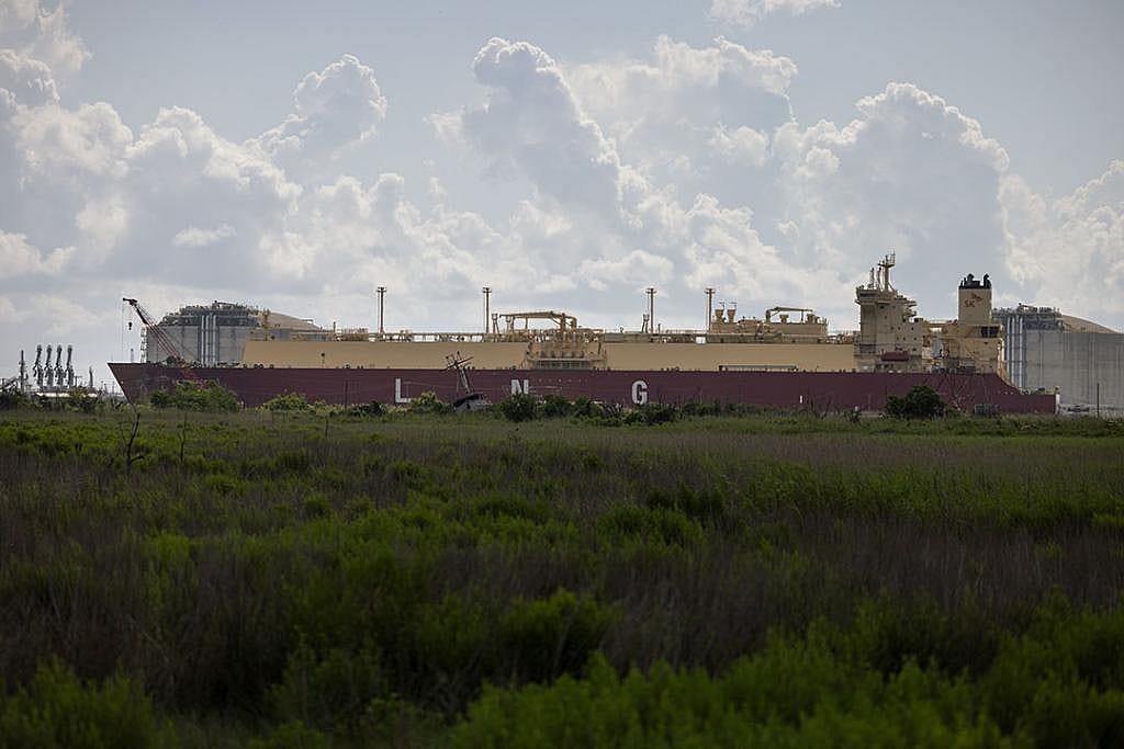 A tanker designed to export liquefied natural gas around the world passes the Calcasieu Pass export terminal In Louisiana. 