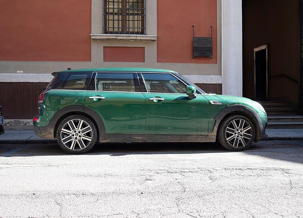 British Racing Green Mini Clubman Cooper S parked in urban setting in Italy.