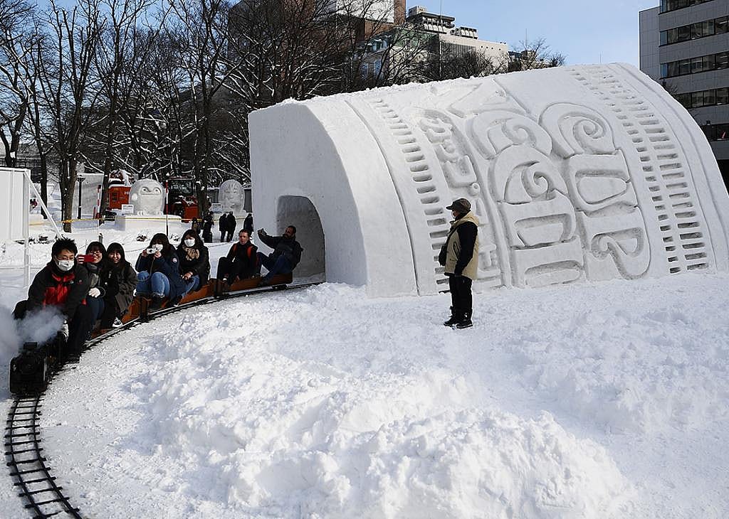 People ride through the Cup Noodles and Rui Hachimura's snow tunnel during the 2020 Sapporo Snow Festival in Hokkaido, Japan.
