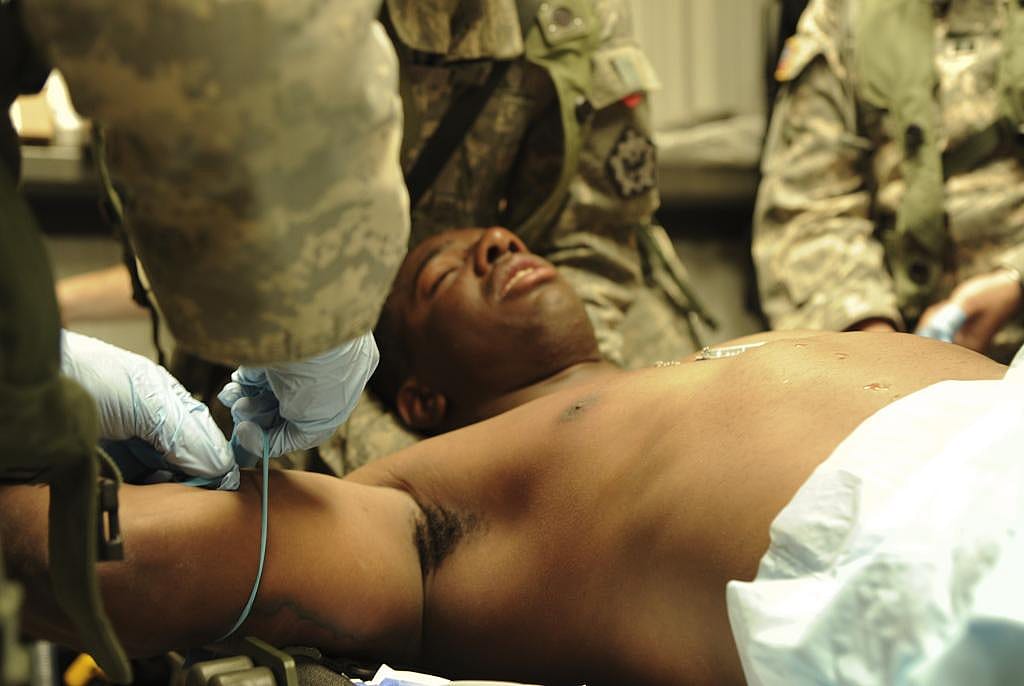  U.S. Army Pvt. Cecil Dean is treated for heat exhaustion by Army medics at Forward Operating Base Maimi, Ft. Irwin Calif., National Training Center, June 12, 2012.
