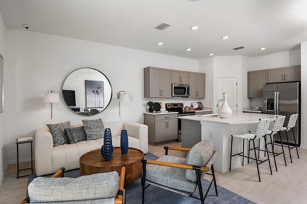 Open concept living room and kitchen in a townhome in Taylor Morrison's Jasmine community 