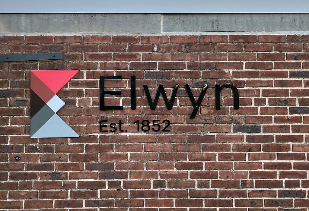 Exterior view of brick wall with signage at Elwyn in Philadelphia, Pennsylvania. 