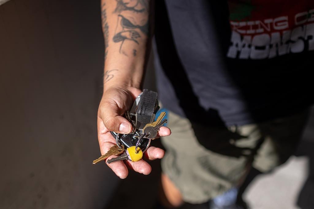 Edgar Rosales Jr. displays the keys to his new home where he will go after spending three years in the Safe Parking Program.