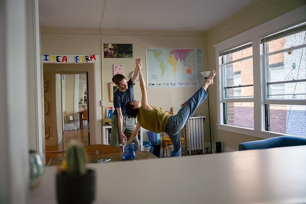 Henry Winslow, left, and Emma Andre rehearse a dance routine in their home in Oakland.