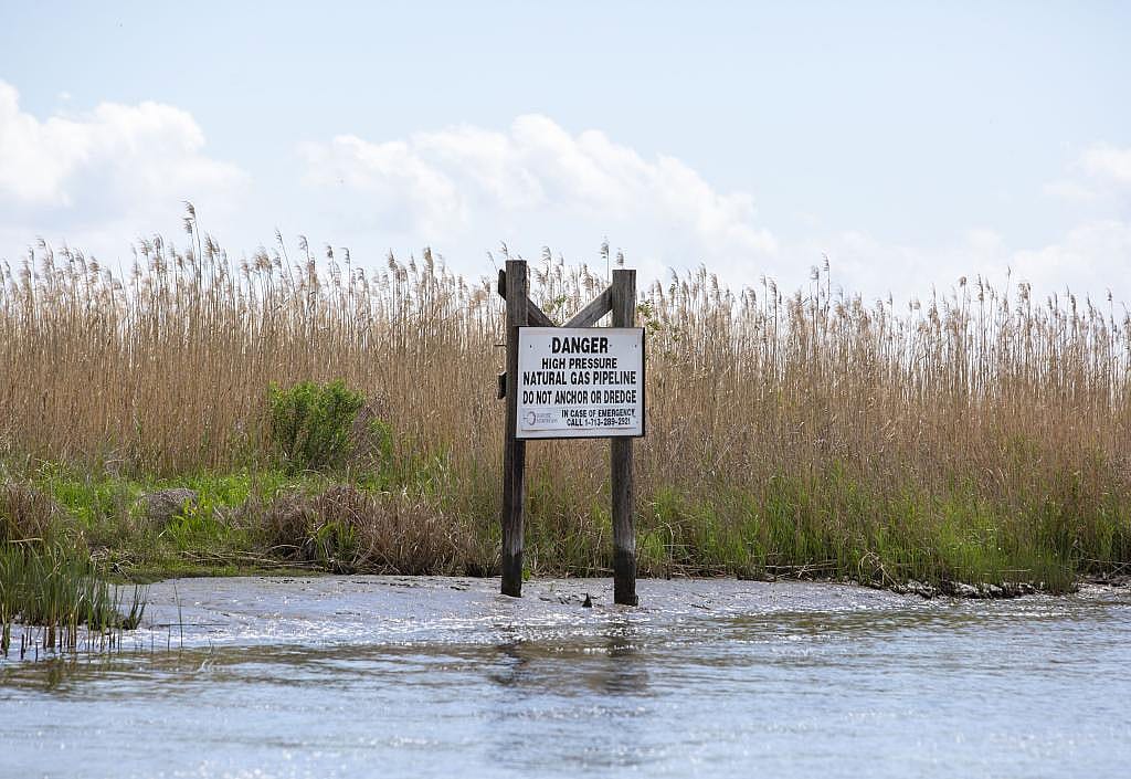 A sign warns of a natural gas pipeline on a canal north of Vermilion Bay on March 27, 2026.
