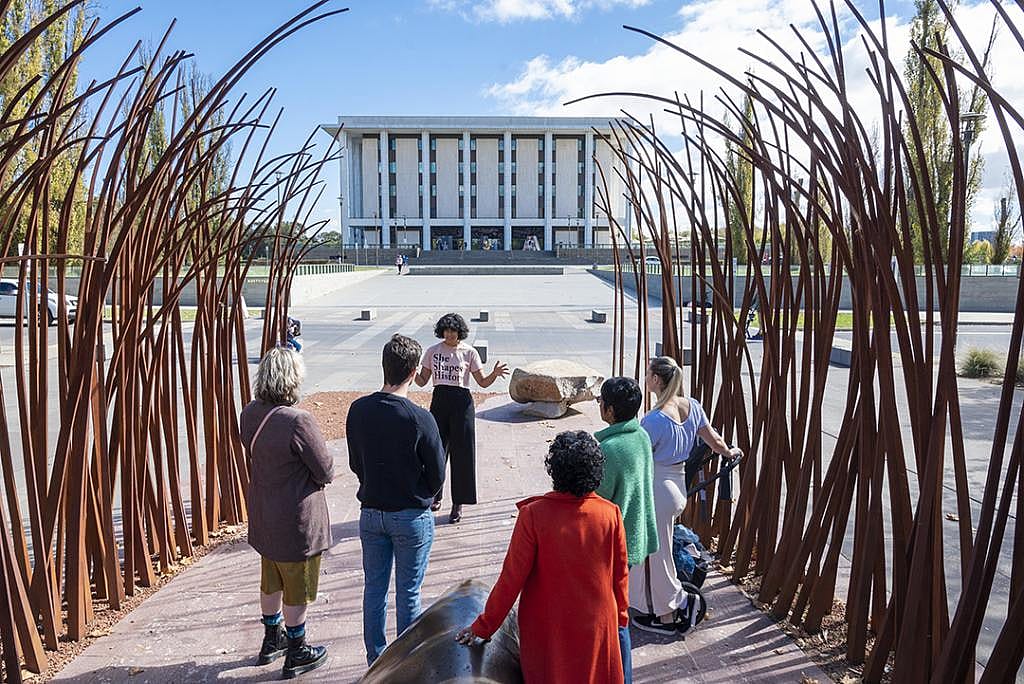 A group being guided by She Shapes History, in front of the National Library of Australia, situated in Parkes, Canberra.