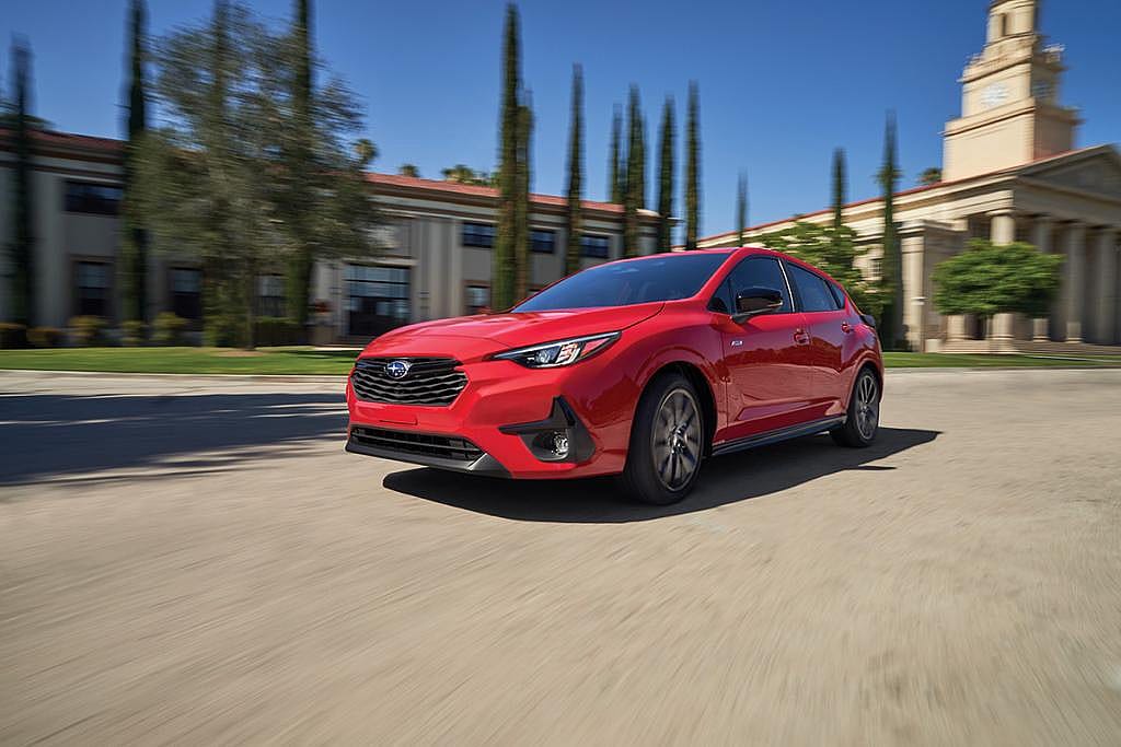 A red 2026 Subaru Impreza car in action.