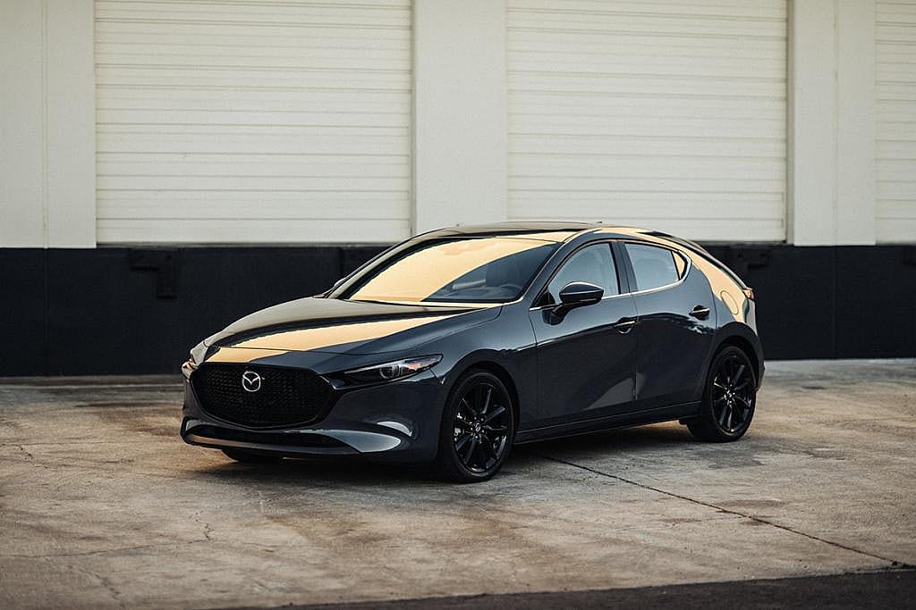 A black 2026 Mazda 3 sedan car on display.