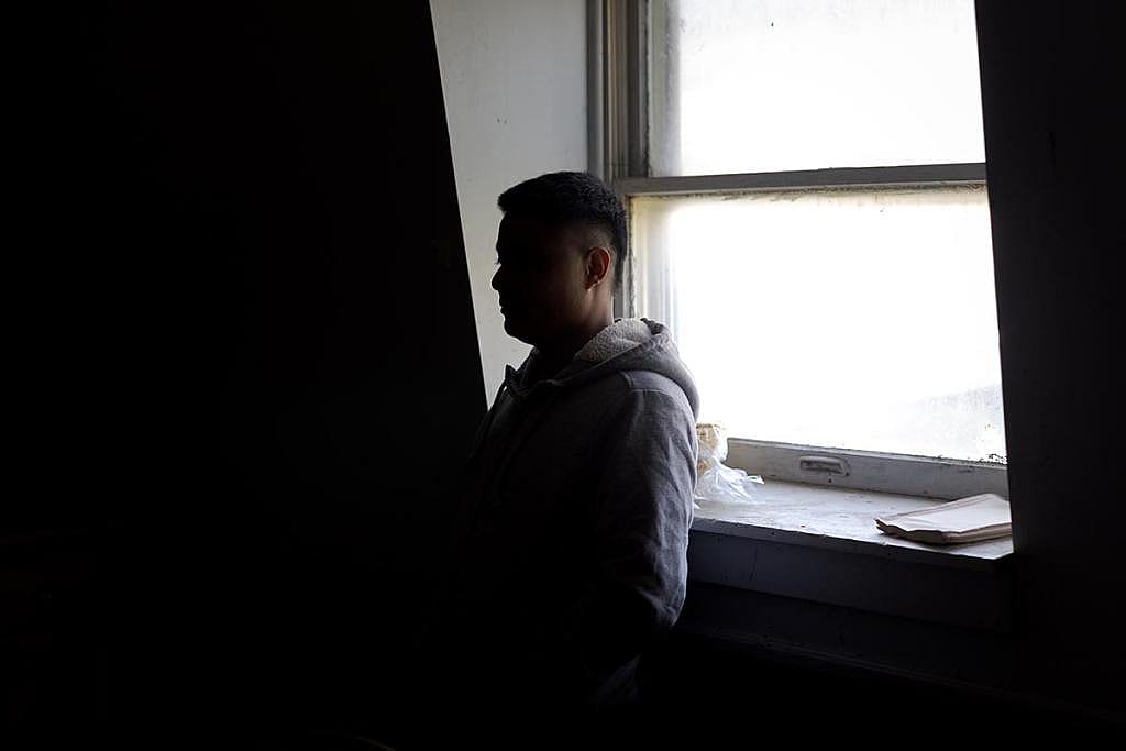 A farm worker in Vermont close to the US-Canada border, who hasn’t left the farm in almost two years out of fear of immigration enforcement stands inside the living quarters he shares with five other workers from Mexico.