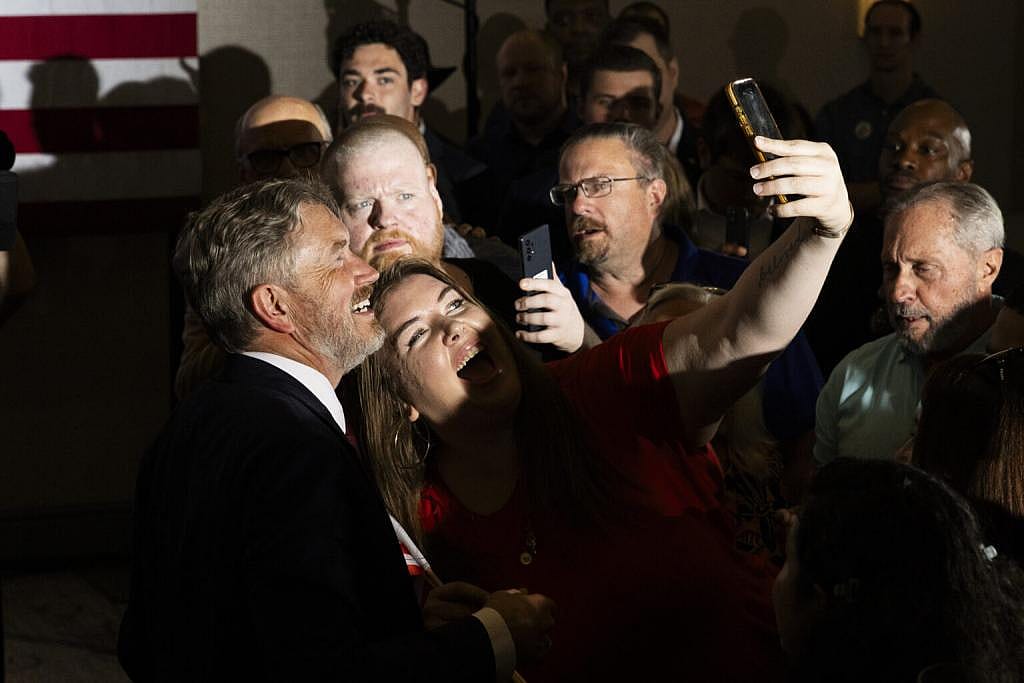 U.S. Rep. Thomas Massie takes photos with his supporters after his concession speech at his watch party in Hebron, Kentucky.
