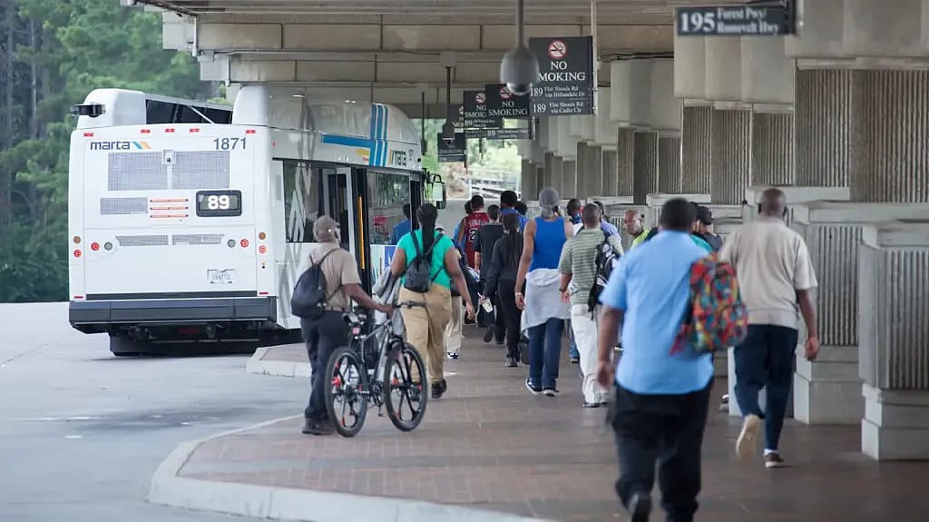 A rear view of people walking toward the 89 bus with Metropolitan Atlanta Rapid Transit Authority which overhauled its bus system in a makeover that nearly tripled the number of residents living near a route with buses that arrive every 15 minutes.