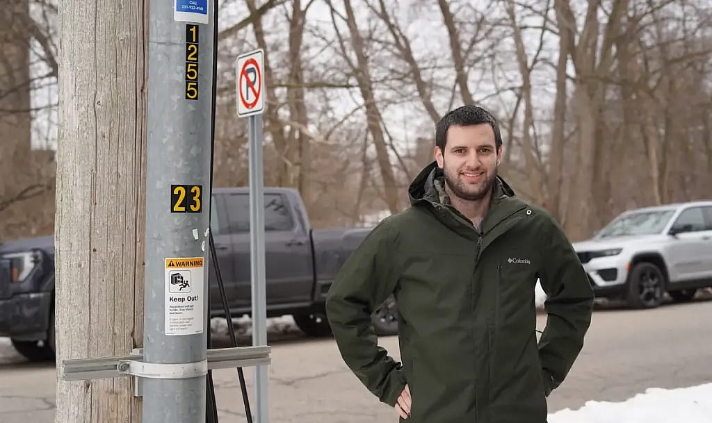 Tony Chartrand, director of electric engineering and operations for Traverse City Light & Power, stands next to a conduit containing an underground wire in Traverse City.