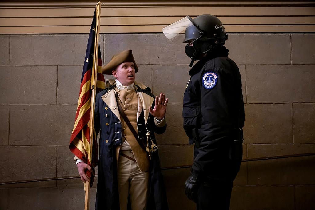 A protester dressed as George Washington debating with a Capitol Police inside the U.S. Capitol in Washington, DC.