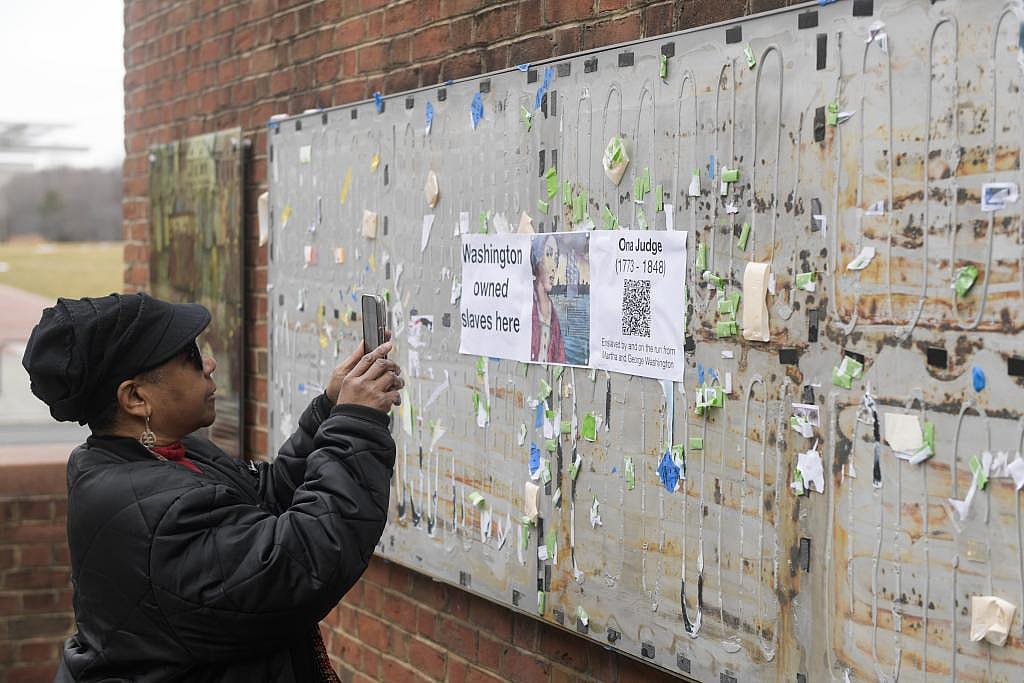 A visitor taking photos of the Freedom and Slavery in the Making of a New Nation exhibit in Philadelphia, Pennsylvania, USA.