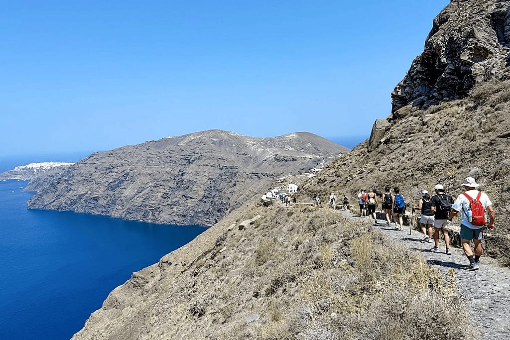 A view of a hiking trail along the Santorini caldera in Greece.