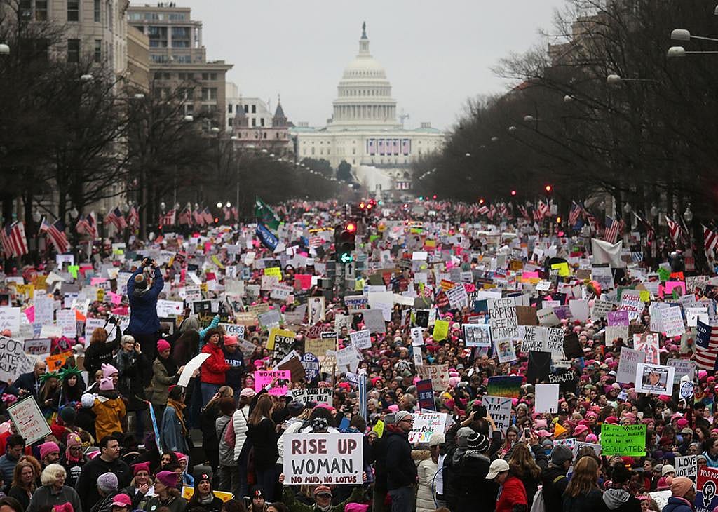 Protesters walk during the Women's March on Washington, with the U.S. Capitol in the background, on January 21, 2017 in Washington, DC.
