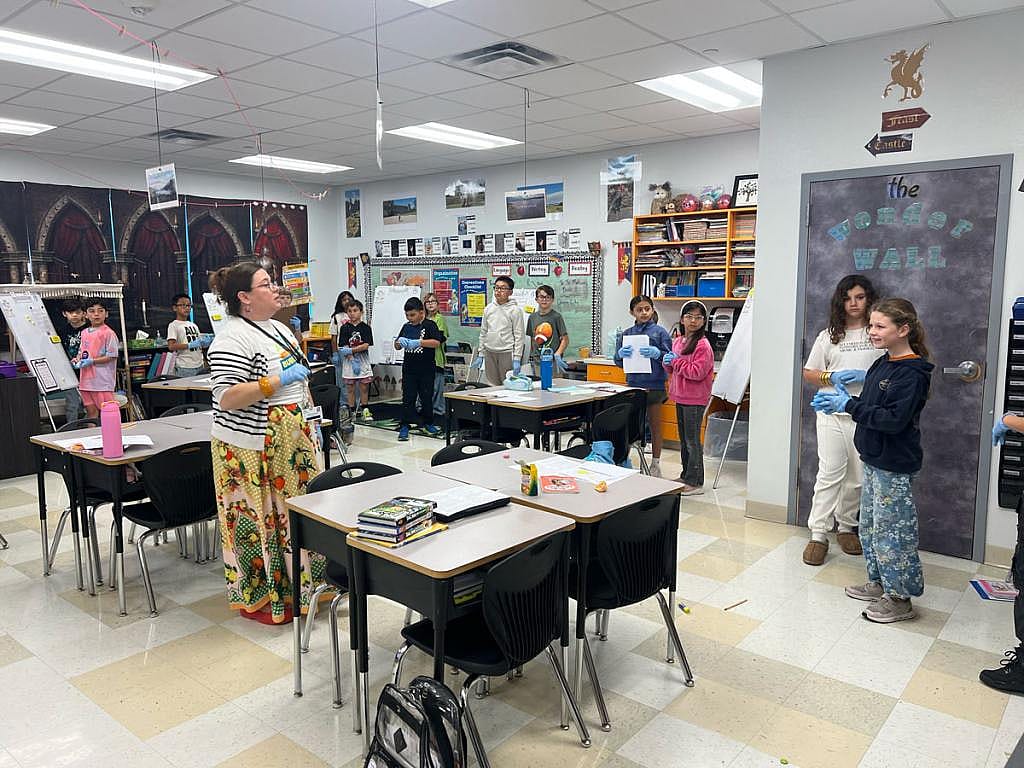 Hanna Patton-Elliott, a third grade teacher at Windsor Park Elementary, instructs her students to be doctors in a reading and writing exercise.