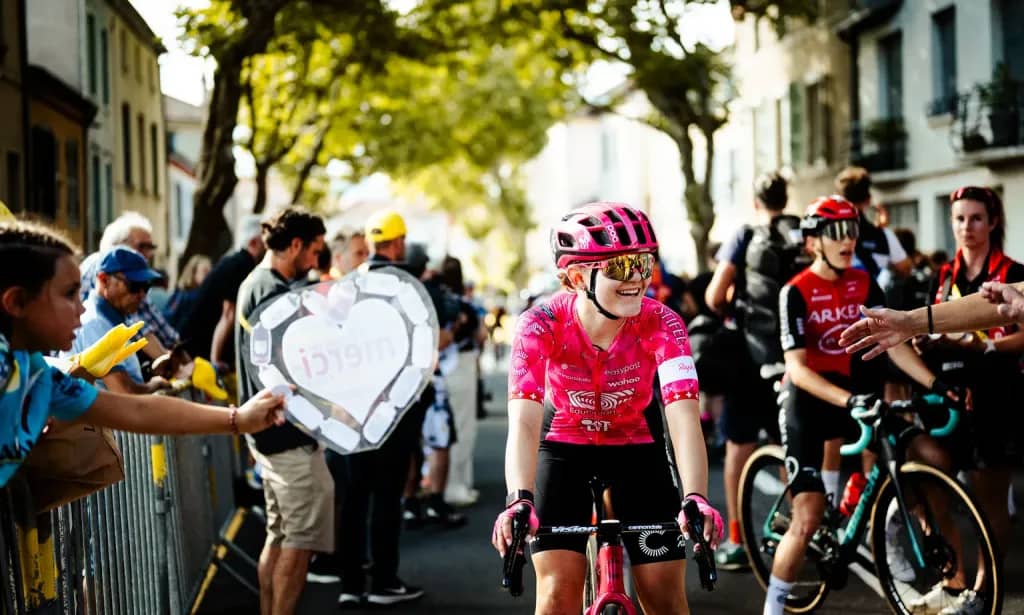 Fans cheering on cyclists along the barriers during the Tour de France Femmes avec Zwift.