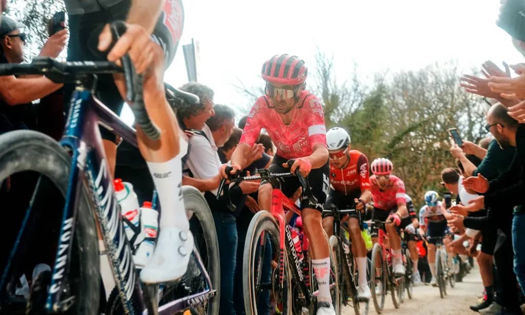Cyclists racing through unpaved gravel paths during the Strade Bianche.
