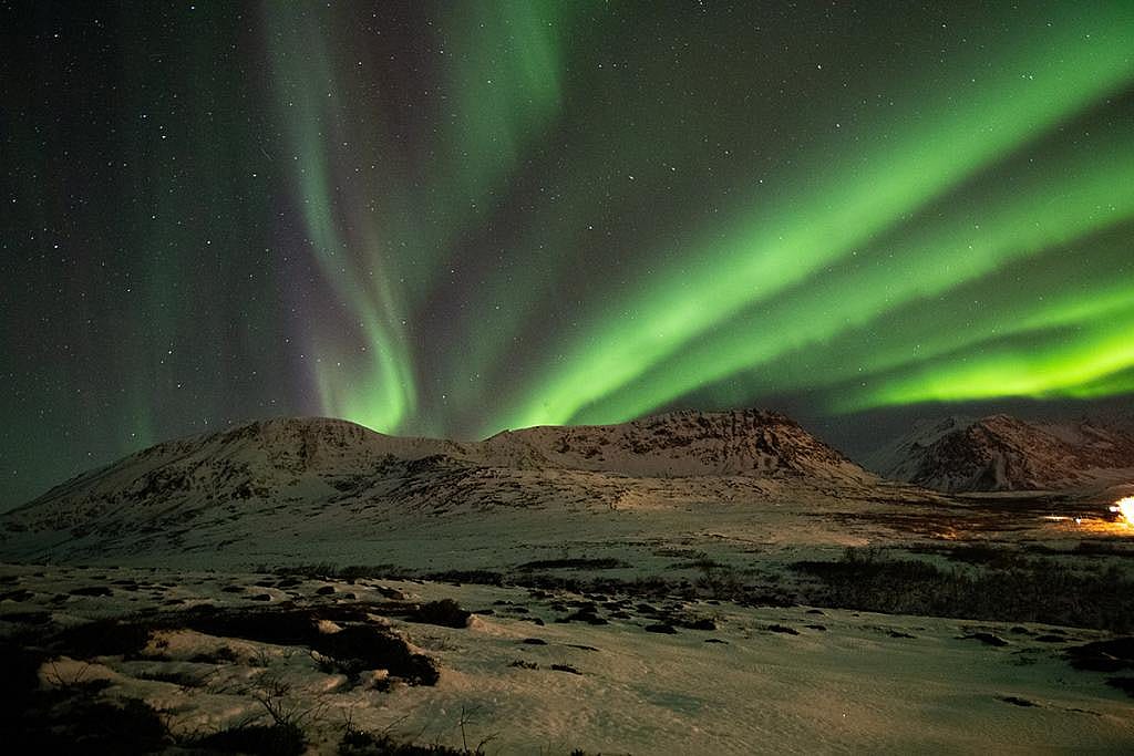 A view of the aurora borealis dancing in the sky in Iceland.