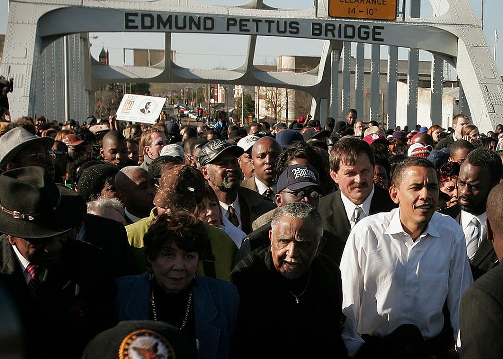 Democratic Presidential candidate Senator Barack Obama (D-IL) (R) marches with a crowd across the Edmund Pettus Bridge to commemorate the 1965 Bloody Sunday Voting Rights March March 4, 2007 in Selma, Alabama. 