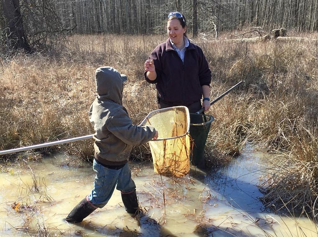 Two people holding nets, wading in water as part of the the Environmental Education Frog Program at Big Oaks National Wildlife Refuge.