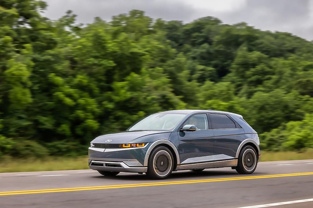2024 Hyundai Ioniq 5 front three-quarter view driving on the road.