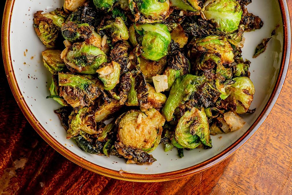 Grilled brussels sprouts with crispy bacon and shallots.