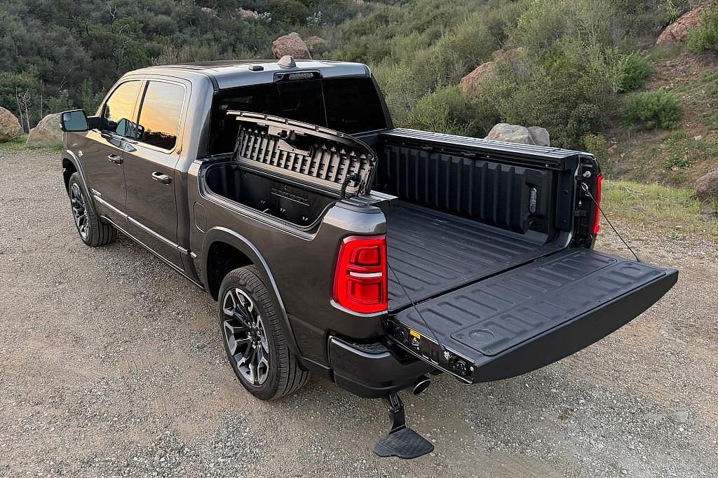 2026 Ram 1500 Limited in Granite Crystal showing the RamBox storage bins, cargo bed, and deployable step.
