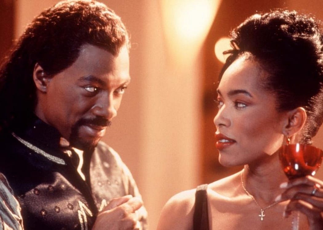 Eddie Murphy looking at Angela Bassett lovingly.