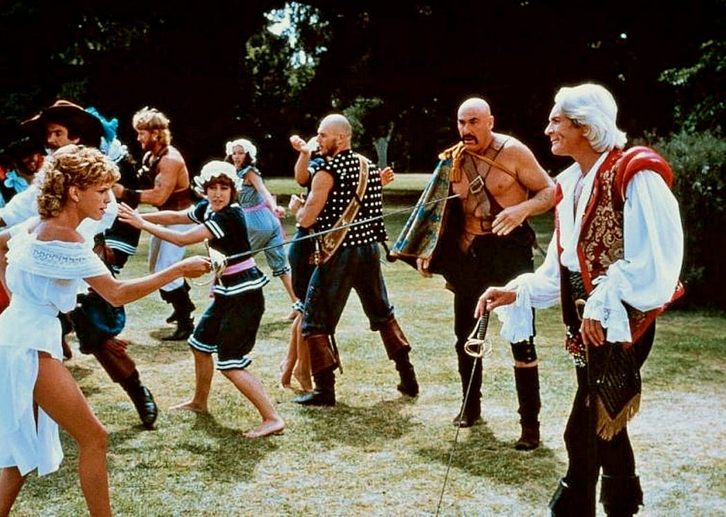 A woman in a white dress with a high slit fighting pirates with a sword.
