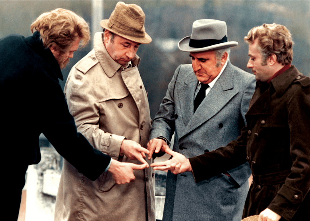 Actors gesture in a scene from ‘Amici miei’