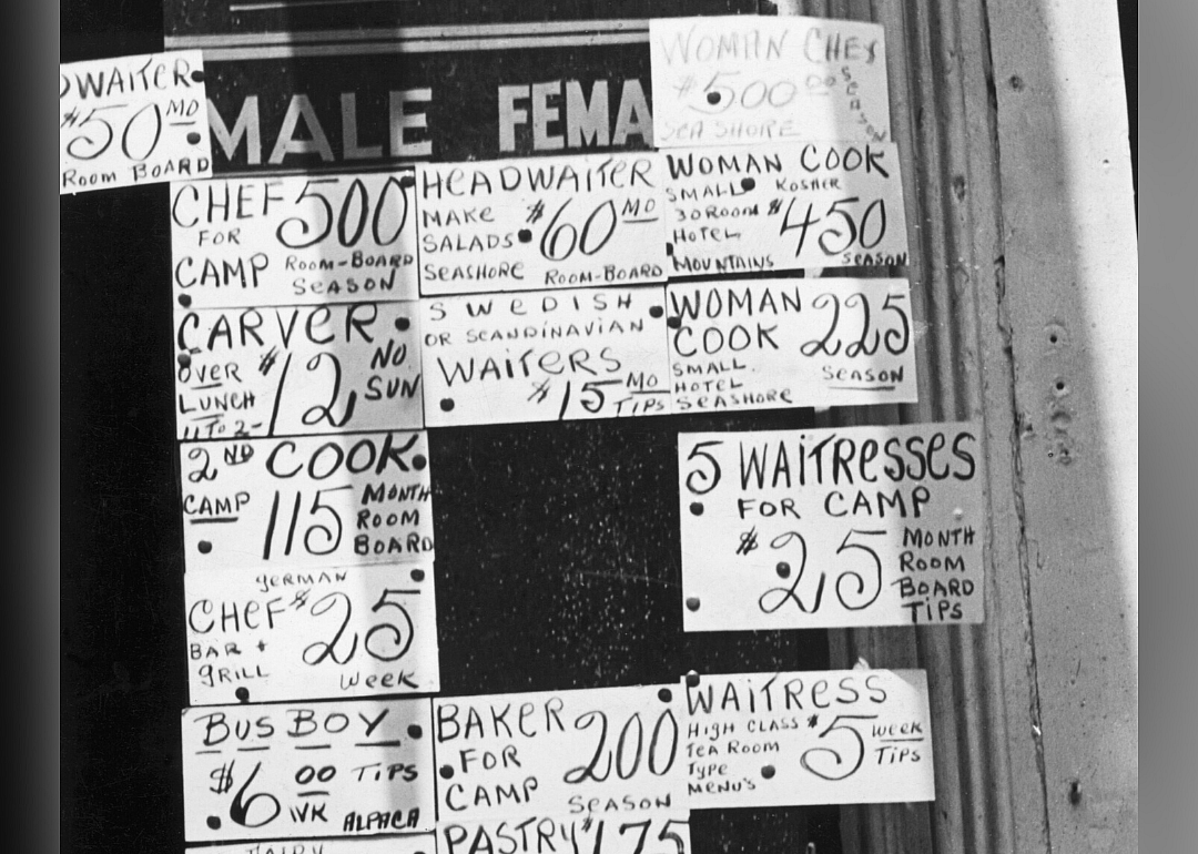 Signs depicting wage scales in 1935
