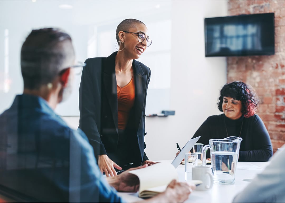 Group of diverse businesspeople collaborate in meeting.