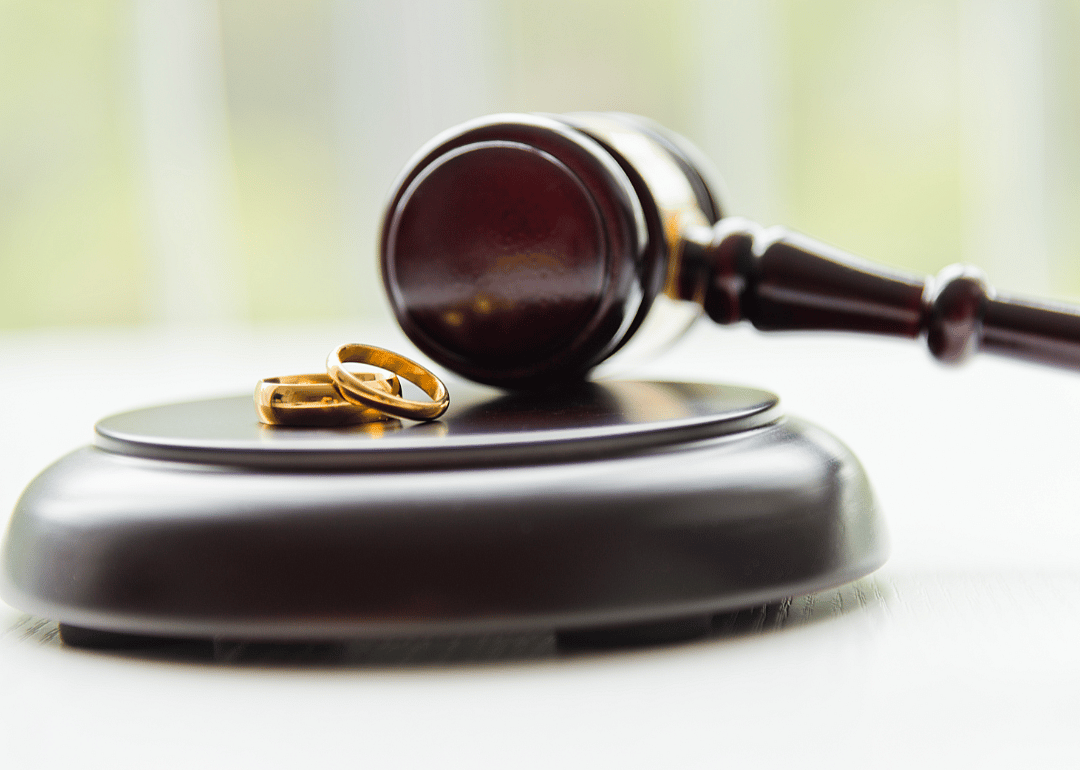 Judge’s gavel with two wedding rings