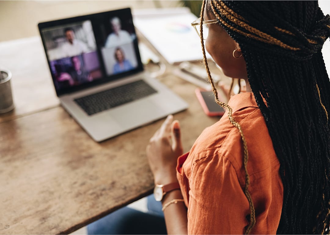 Professional participates in virtual meeting.