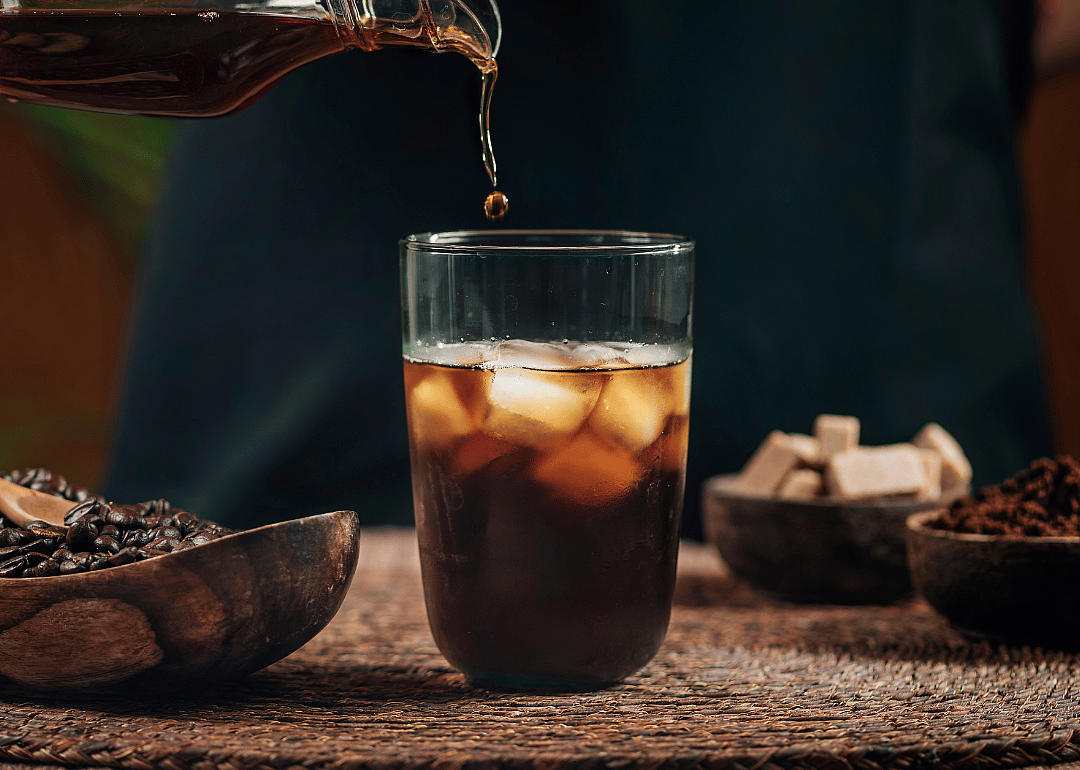 Iced coffee drink being poured.