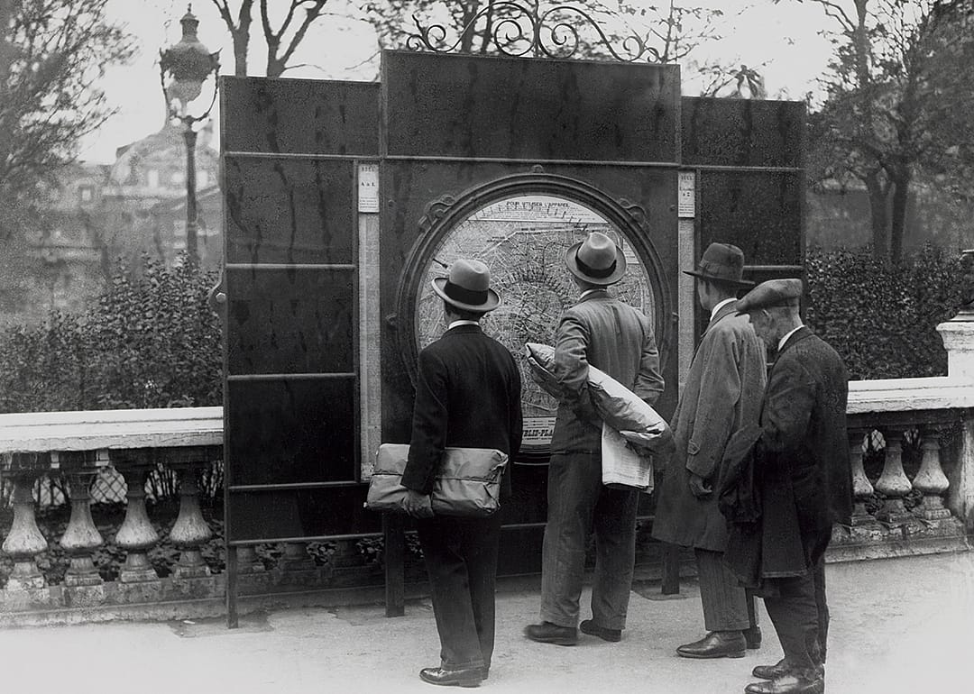 Pedestrians looking at street map.
