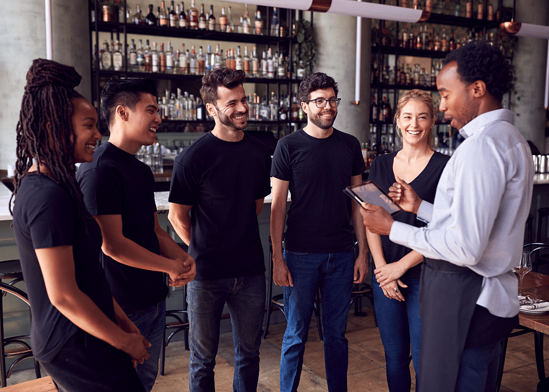 Restaurant manager talking to team.