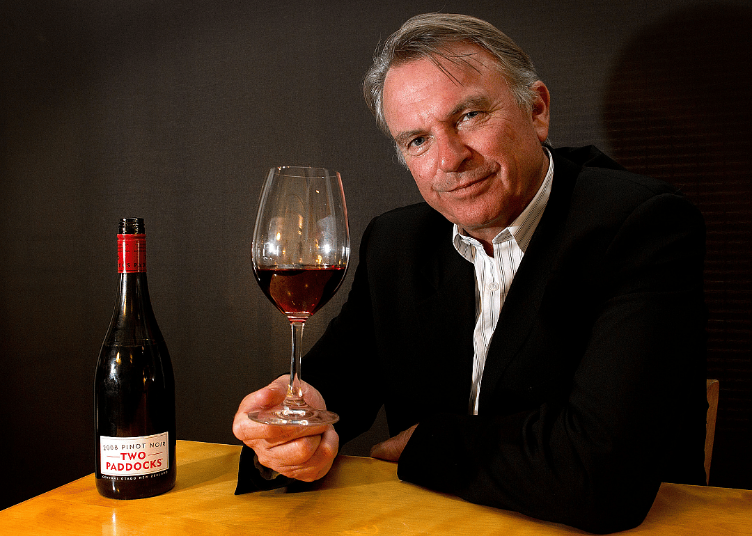 Sam Neil poses with bottle of wine