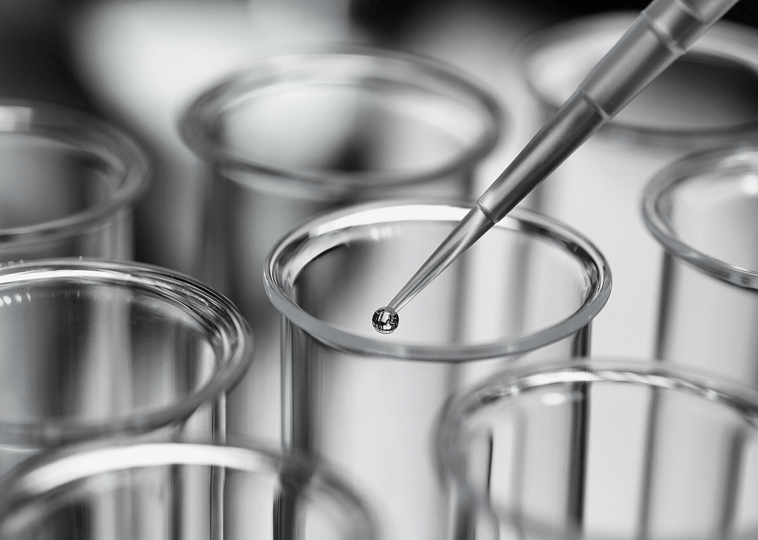 Close-up view of pipette and test tube in a laboratory.