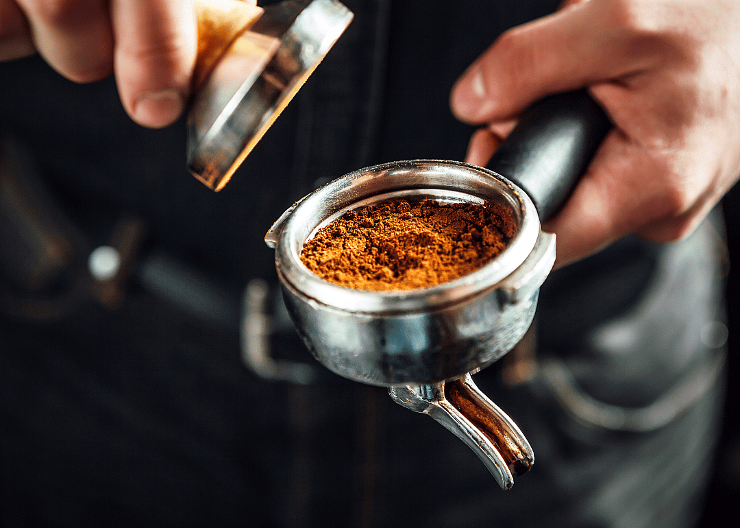 Barista preparing ground espresso.