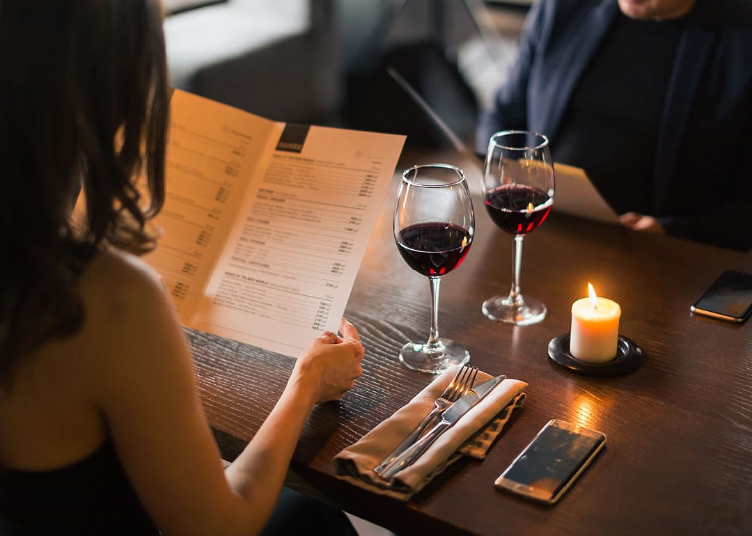 Couple with menu in a restaurant