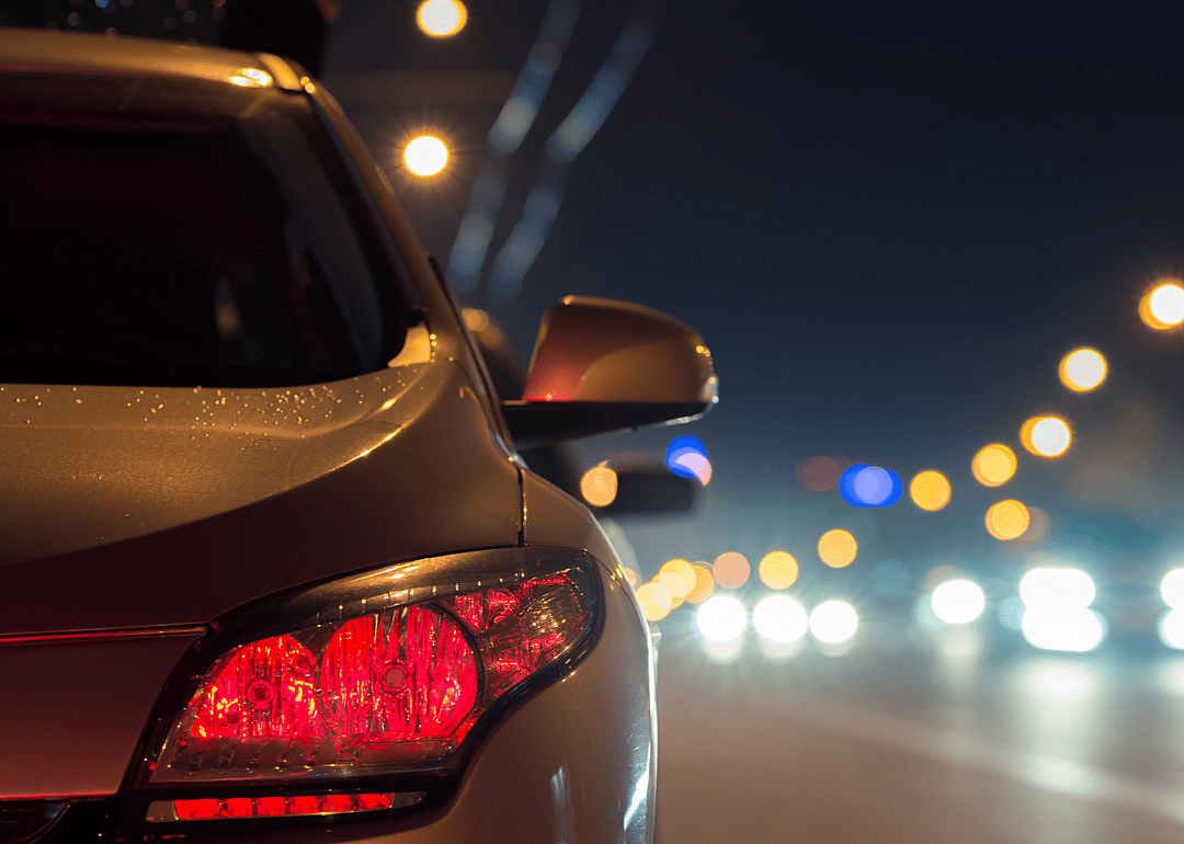 Car stopped on urban highway at night